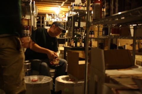 Chris Lively taps a keg of Allagash Koelschip blend #9 in Ebenezer's cellar