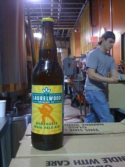 Workhorse IPA in the bottle (brewer Cam Eron in the background) Photo courtesy of Laurelwood