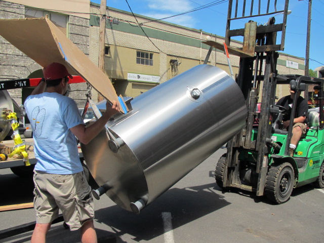 Mt Tabor founder/brewer Eric Surface (left) and Practical Fusion fabricator Colin Preston unload new tank