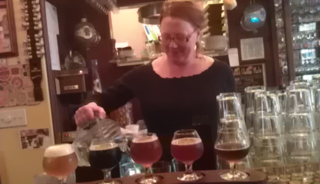 Saraveza Beertender Kate Vincent procures a beer sampler platter
