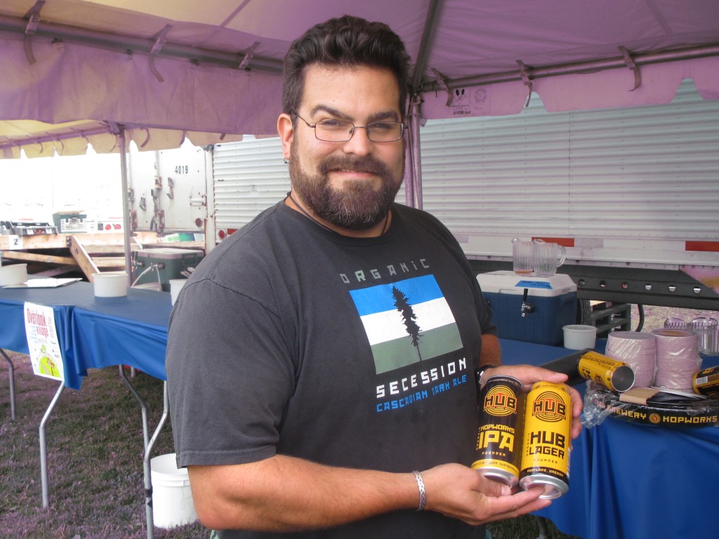 Hopworks Urban Brewery's Jaime Rodriguez shows off the new canned brews at 2012 NAOBF