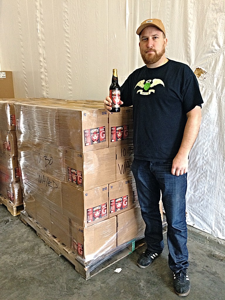 Gigantic Brewing's Ben Love overlooking the 100 cases of MASSIVE 2013 Bourbon Barrel Aged