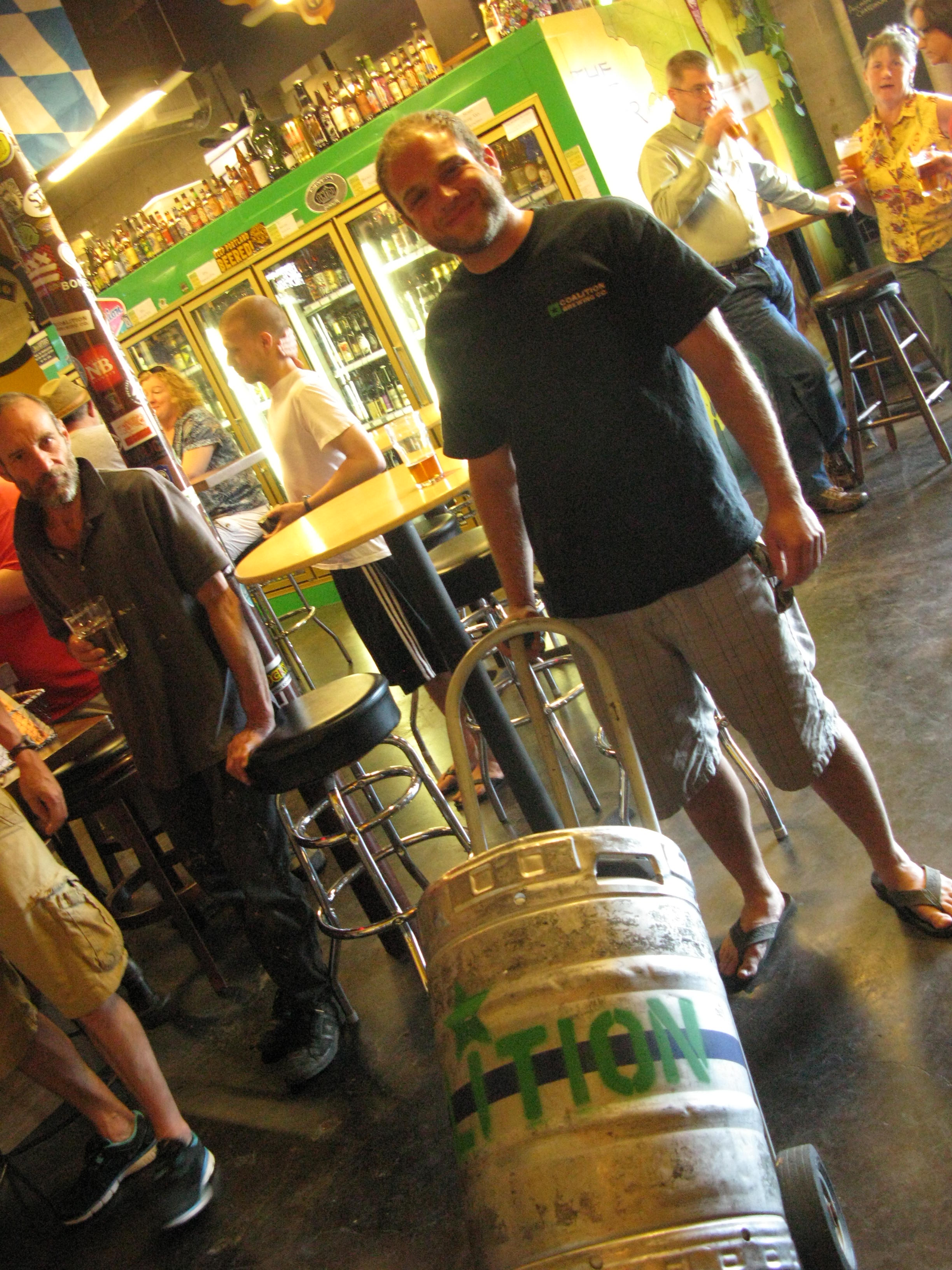 Elan from Coalition Brewing moving a keg at The BeerMongers (FoystonFoto)