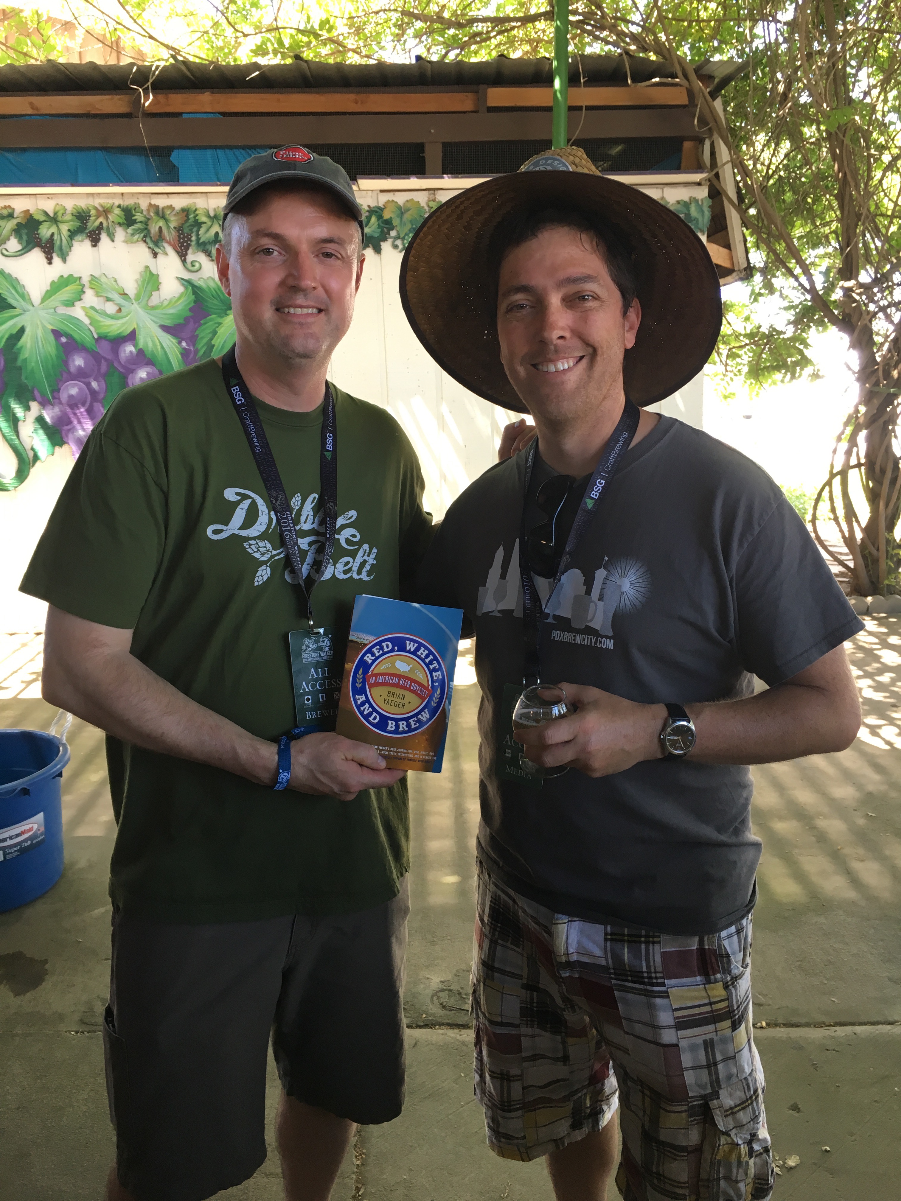 Brian Yaeger (left) giving Vinnie Cilurzo, founder of Russian River Brewing, his book Red, White, And Brew at the 2016 Firestone Walker Invitational Beer Fest.