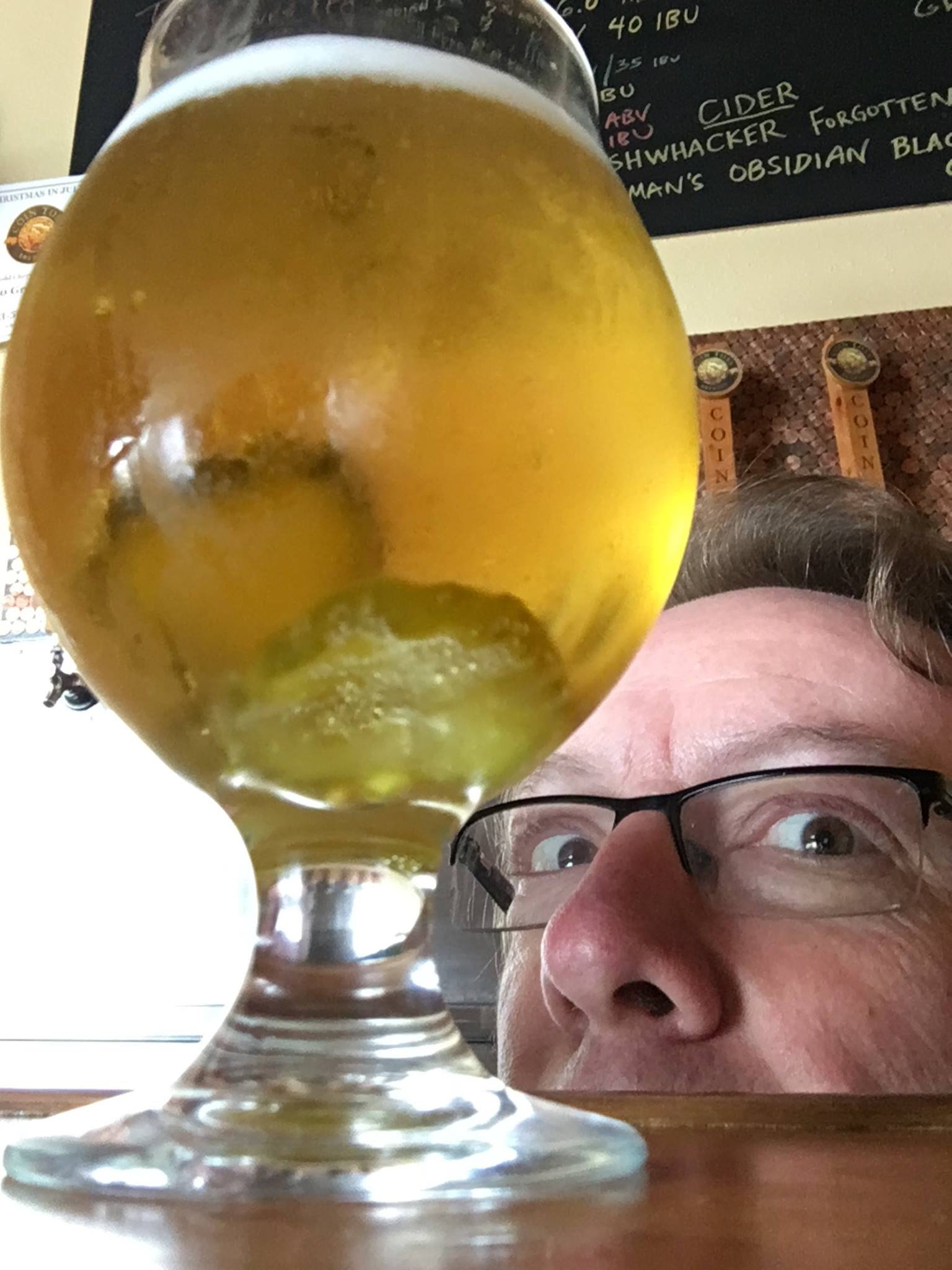 Tim Hohl of Coin Toss Brewing Co. inspects his new Caught In A Pickle Lager that will be features at the Great West Brew Fest. (image courtesy of Coin Toss Brewing)