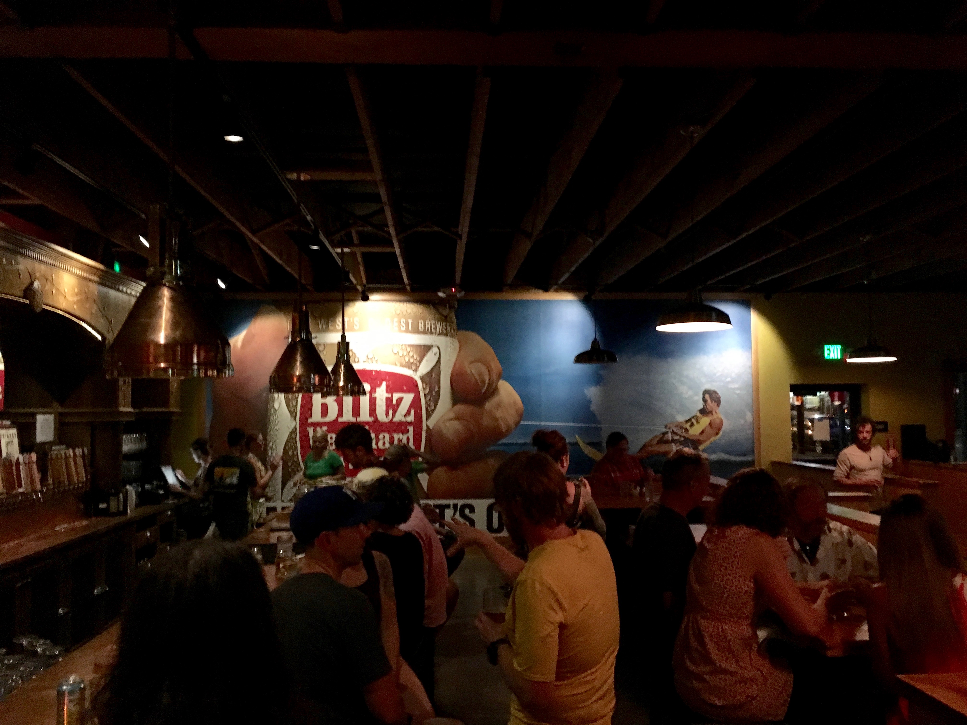 Looking down the bar at Double Mountain Taproom with the Blitz Weinhard mural in the background.