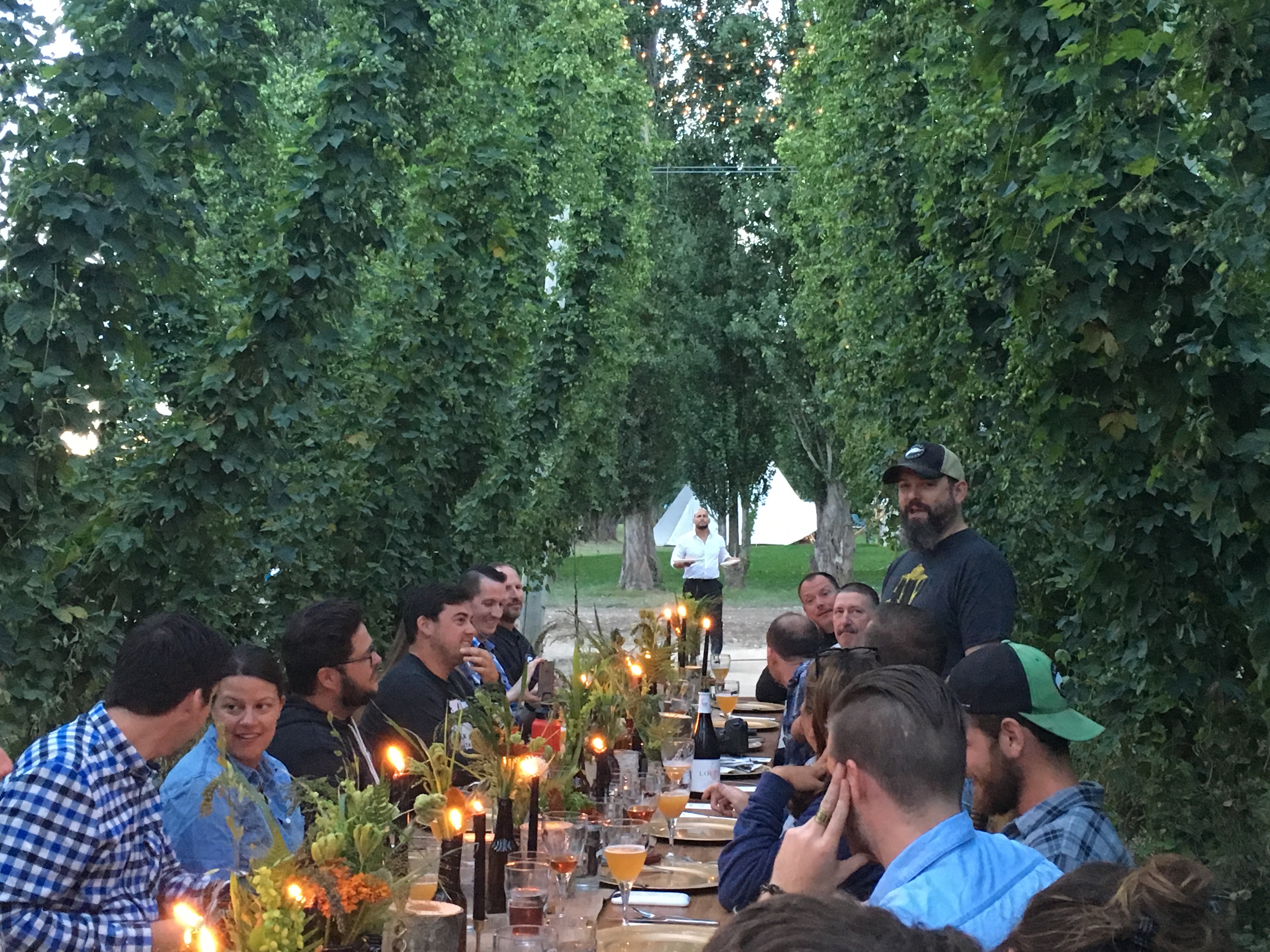 Goose Island brewer Keith Gabbett discussing the a beer while having dinner in the hop fields at Elk Mountain Farms.