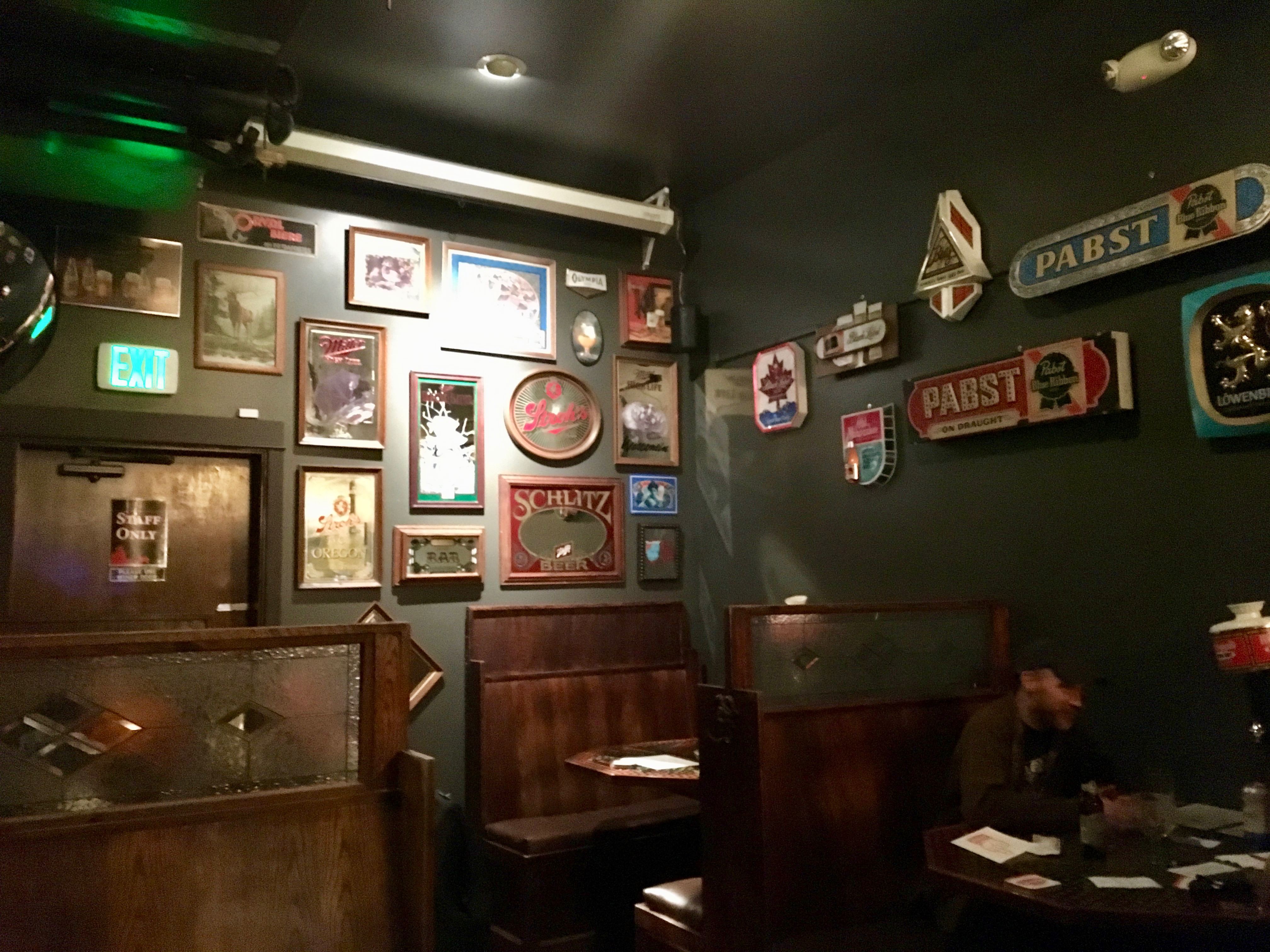 The back wall at Saraveza has been redecorated with a focus on old beer mirrors. Gone is the old chalkboard taplist on the wall.