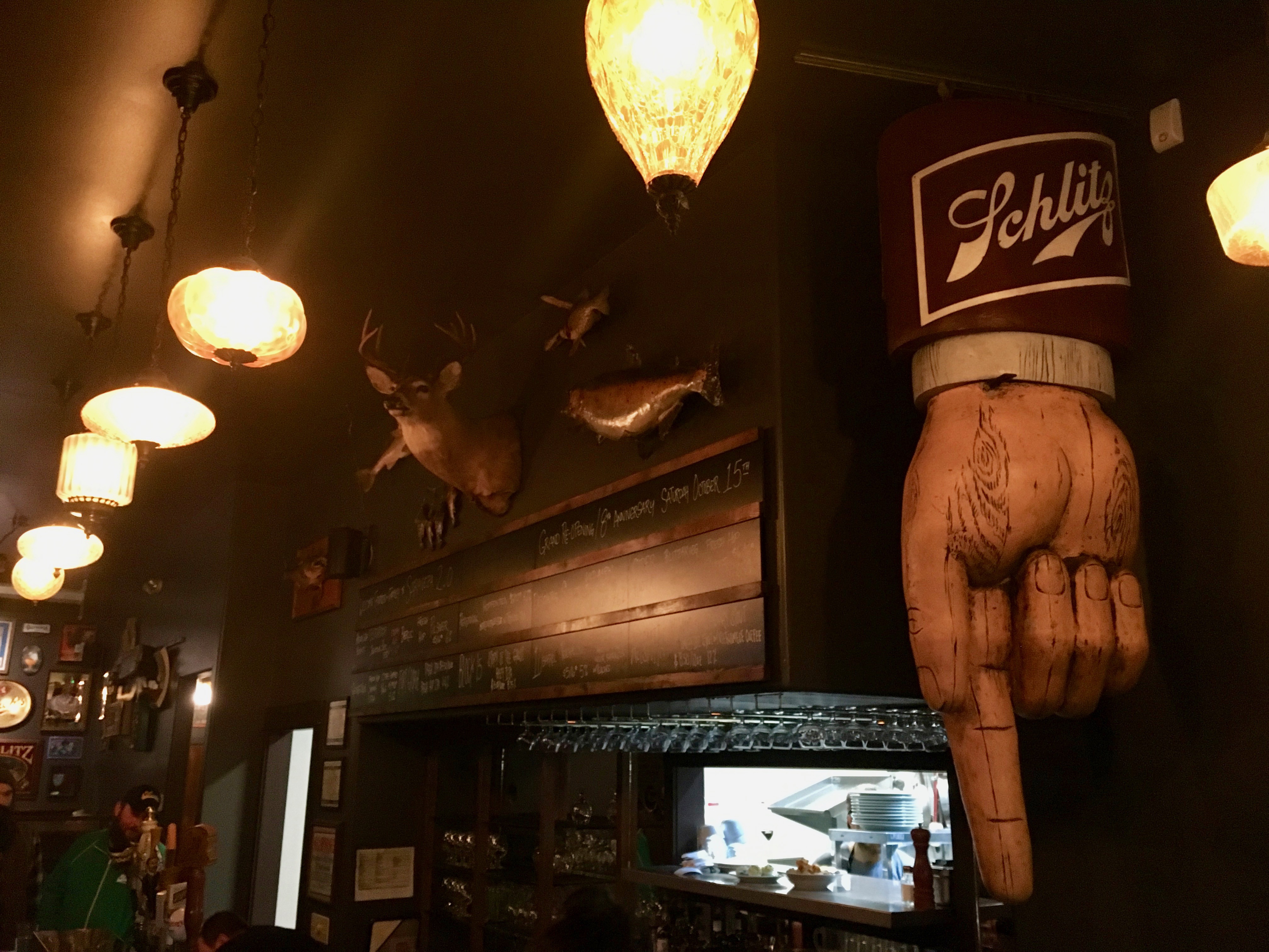 The iconic Schlitz Hand still hangs behind the bar at the newly remodeled Saraveza.