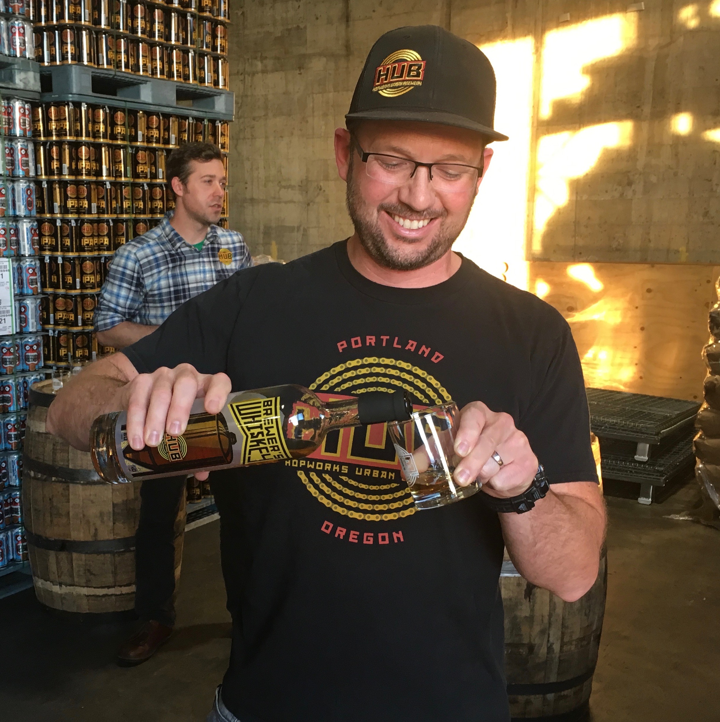 Hopworks Urban Brewery founder Christian Ettinger pours a glass of HUB Brewer's Whiskey.
