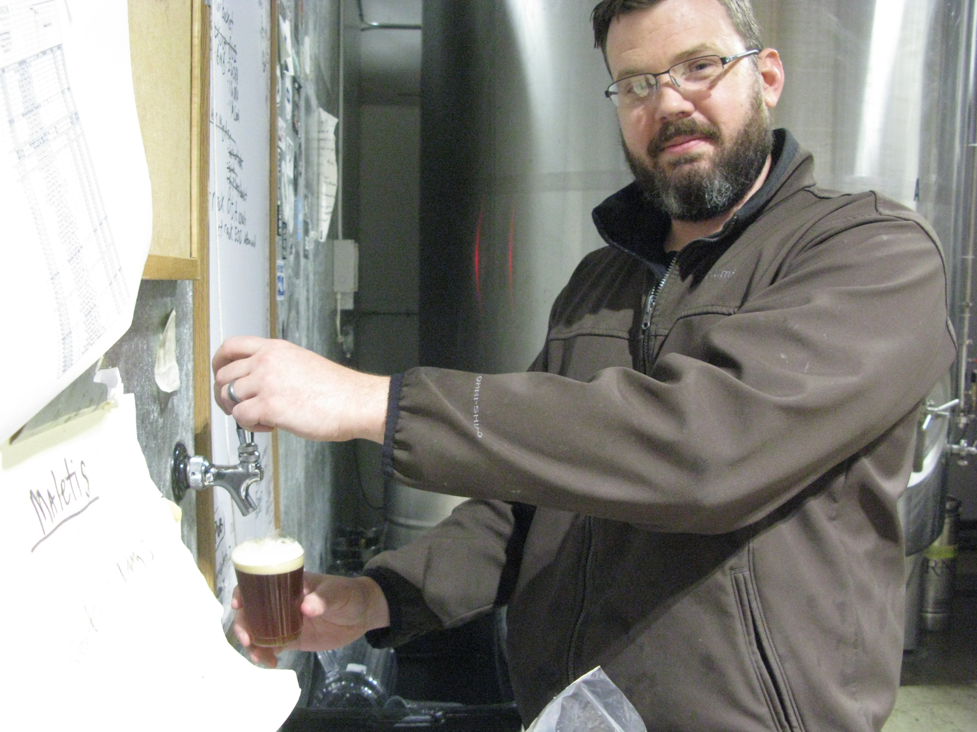 Kory from Burnside Brewing pouring a glass of Permafrost. (FoystonFoto)