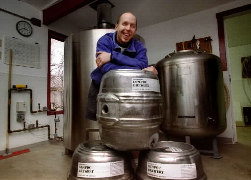 Lompoc owner Jerry Fechter a couple of decades ago in the first Lompoc brewery, which had a lot of Grundy fermenters on roll-around wheels. (image courtesy of Lompoc Brewing)