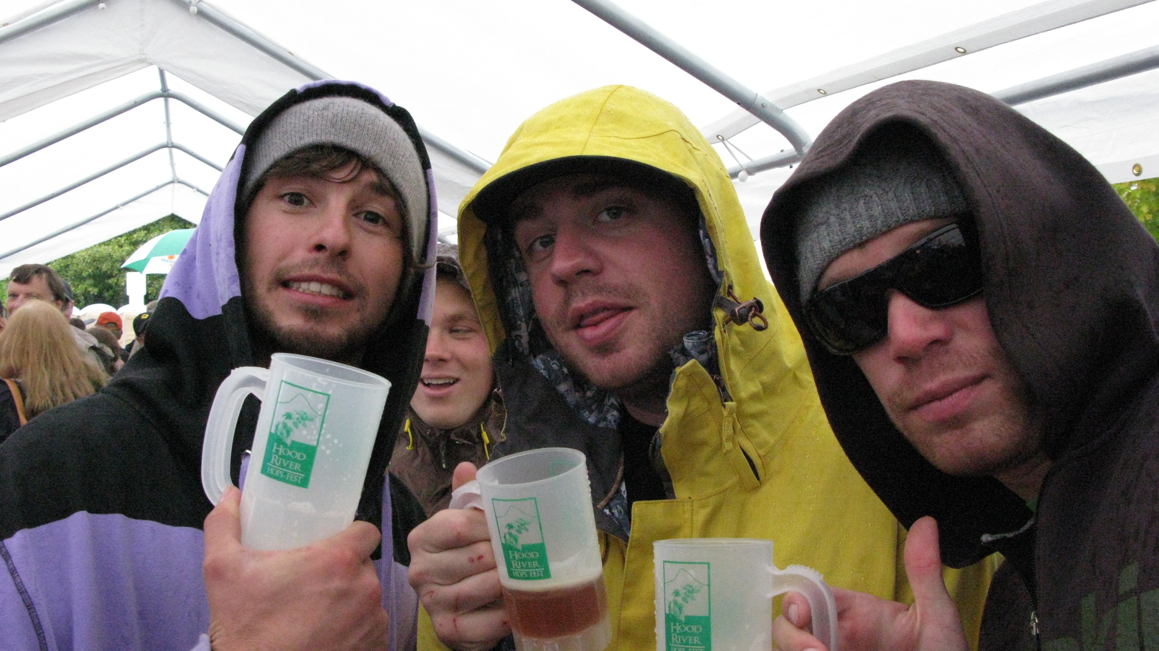 This trio of diehard beer fans braved a rainy Hood River Hops fest a few years ago, so drinking beer while watching snow showers from a heated tent in Bend should be a cinch...(FoystonFoto)