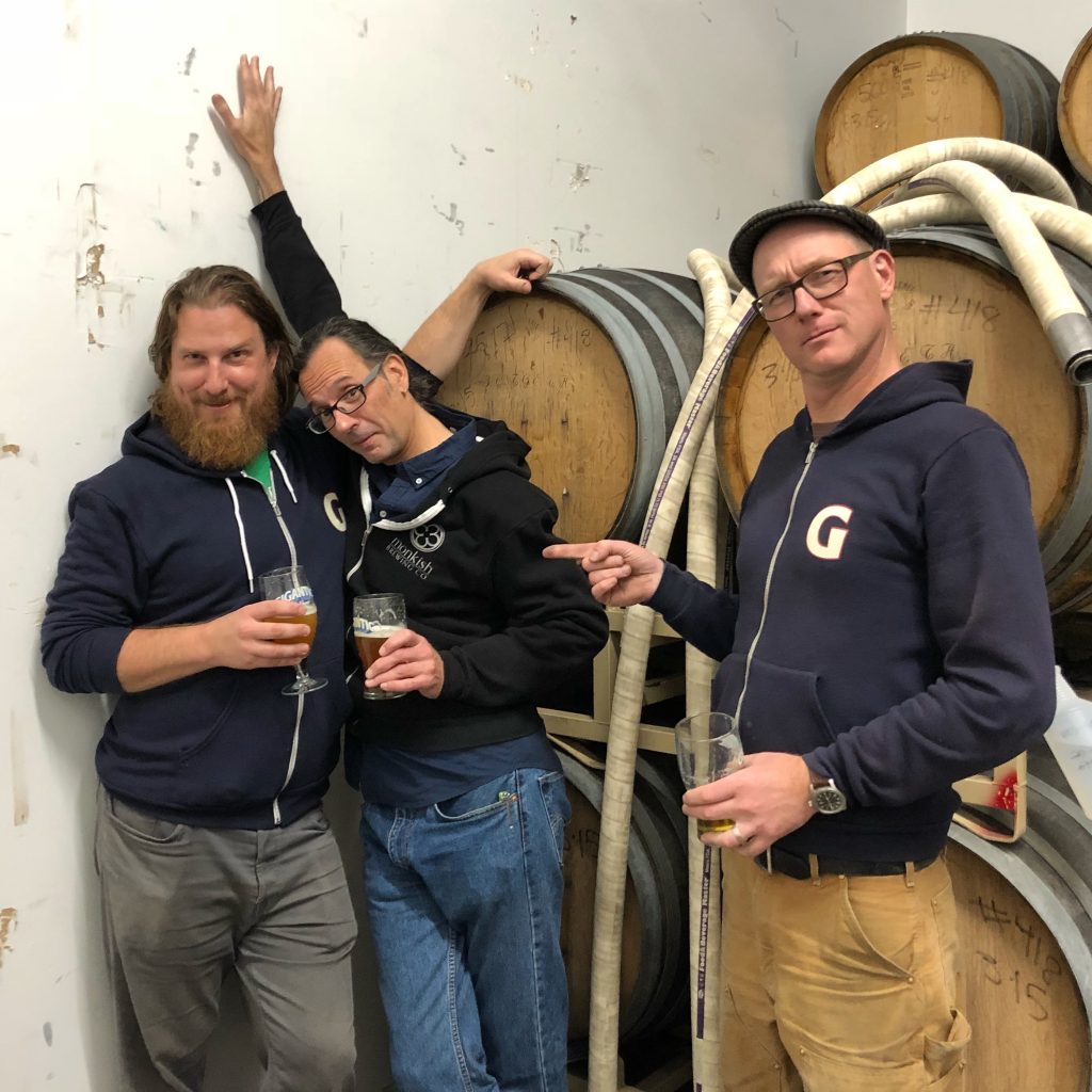 Ben Love and Van Havig of Gigantic Brewing surround Ron Jeffries from Jolly Pumpkin.