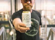 image of Matt Brynildson holding a can of Firestone Lager courtesy of Firestone Walker Brewing