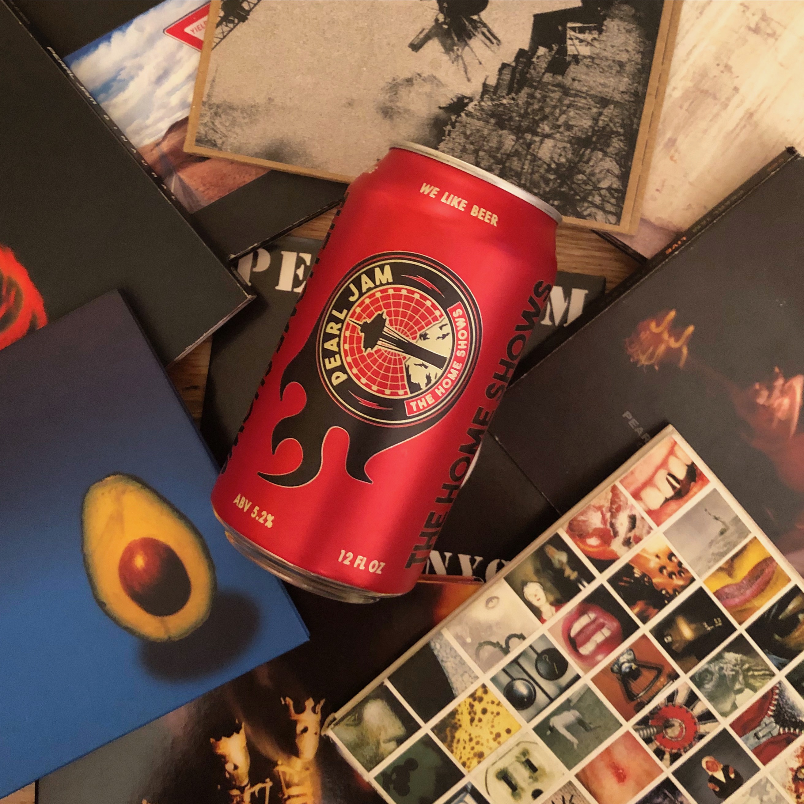 A collage of Pearl Jam CDs with a can of Georgetown Brewing The Home Shows Seattle Pale Ale. This beer is brewed in conjunction with Pearl Jam and its Vitalogy Foundation.