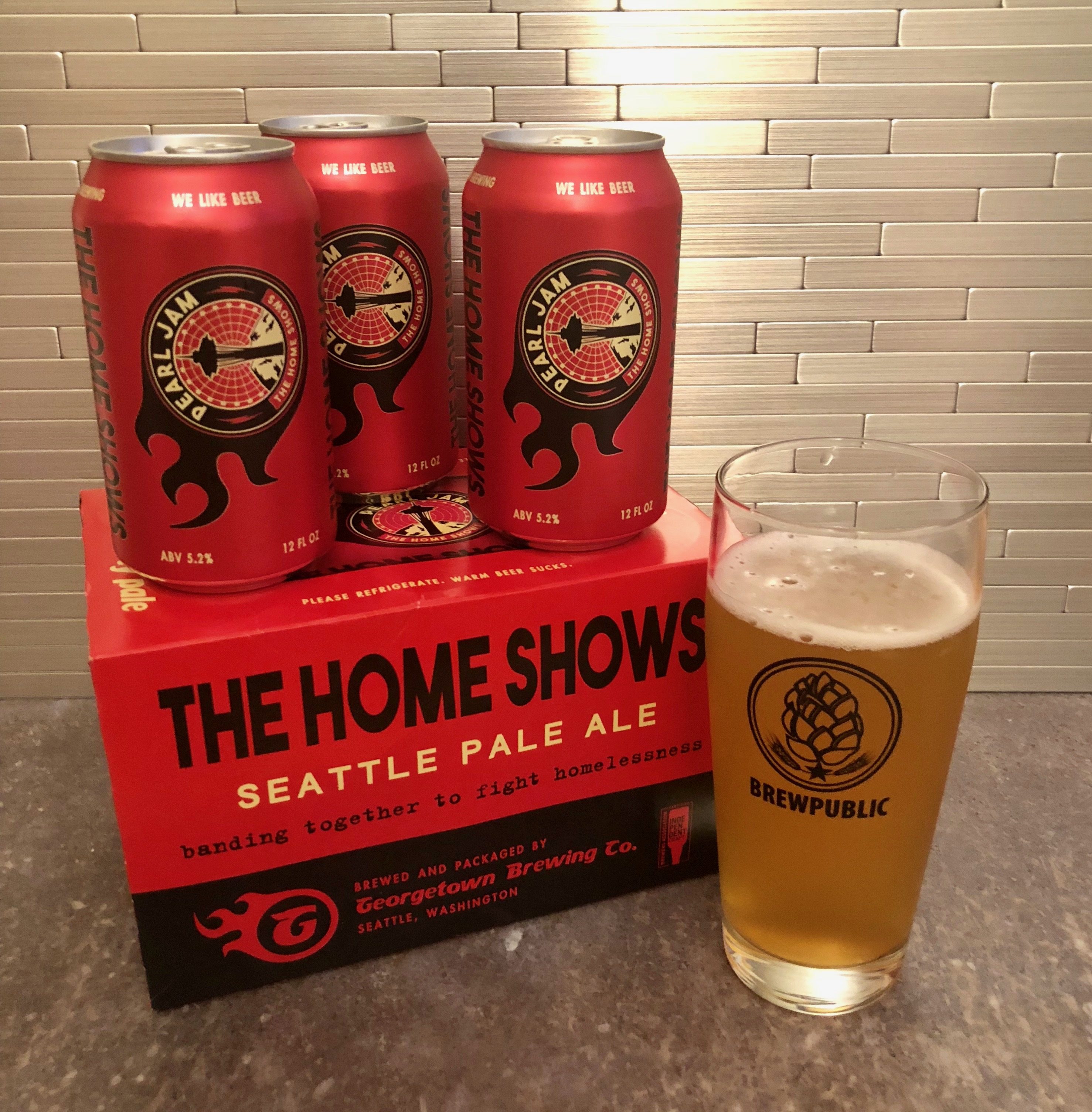 A glass pour of Georgetown Brewing The Home Shows Seattle Pale Ale in a BREWPUBLIC glass. This beer is brewed in conjunction with Pearl Jam and its Vitalogy Foundation.