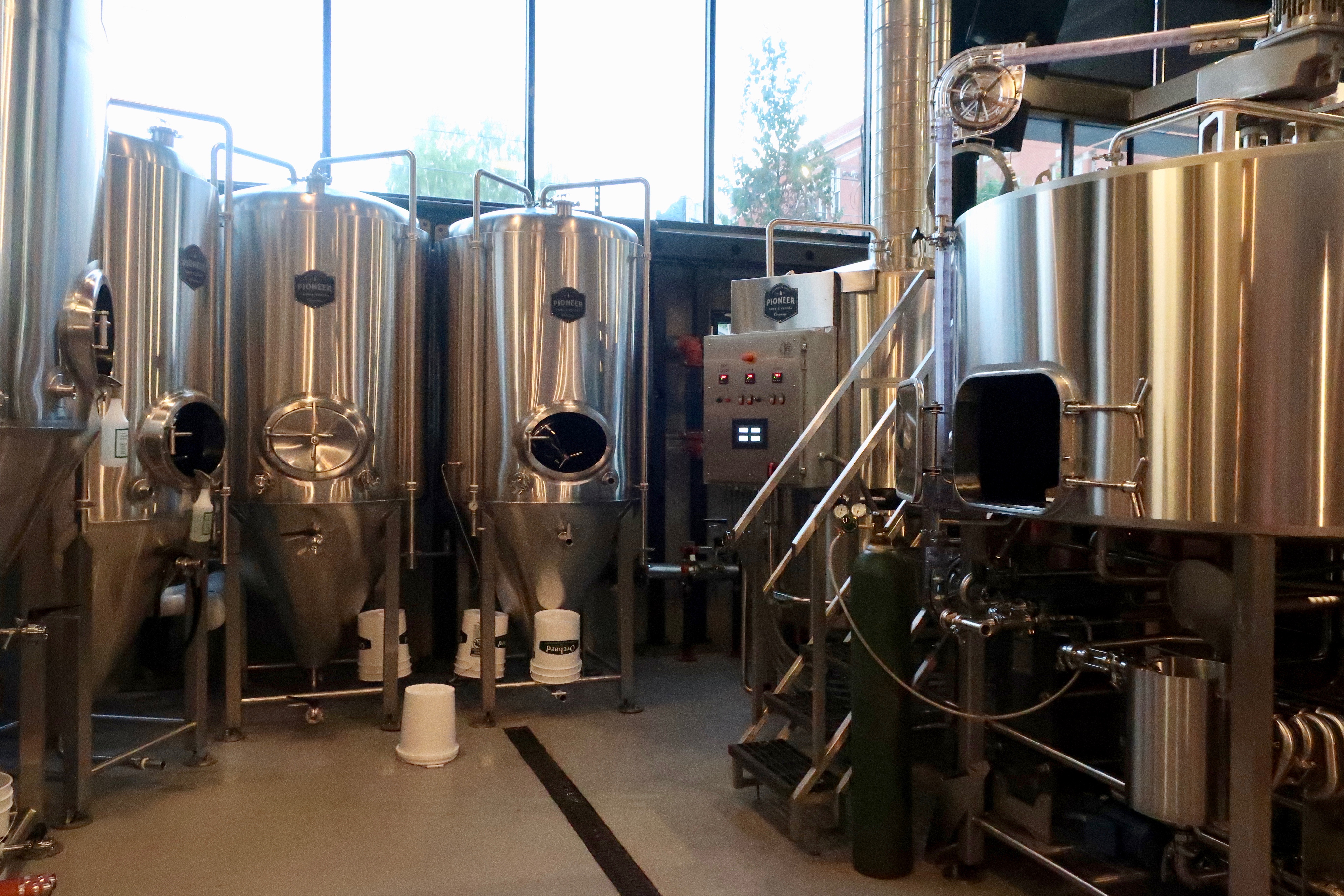 Peeking into the 15-barrel brewhouse from the dinning area at West Coast Grocery Co..