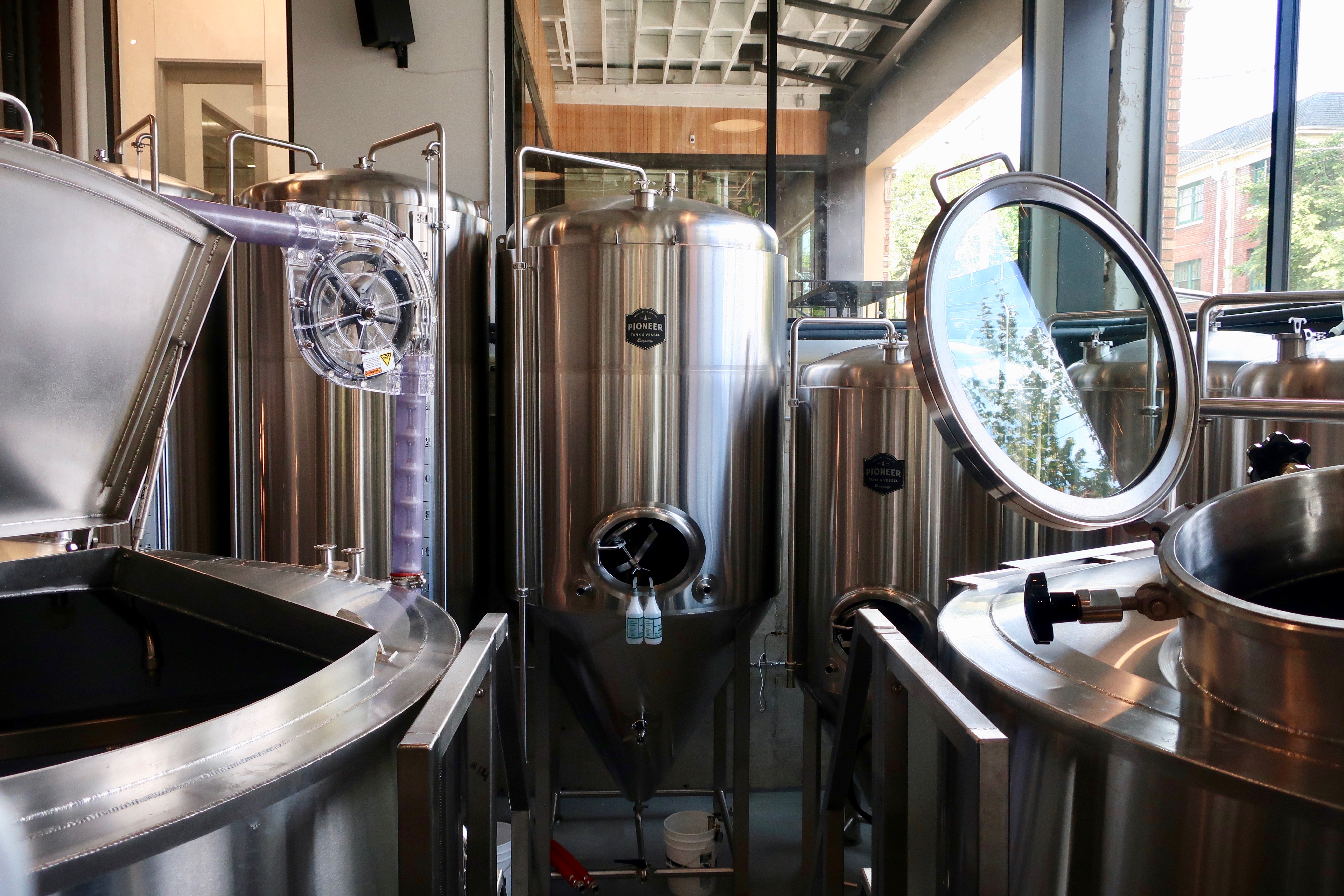 Peeking into the 15-barrel brewhouse from the dinning area at West Coast Grocery Co..
