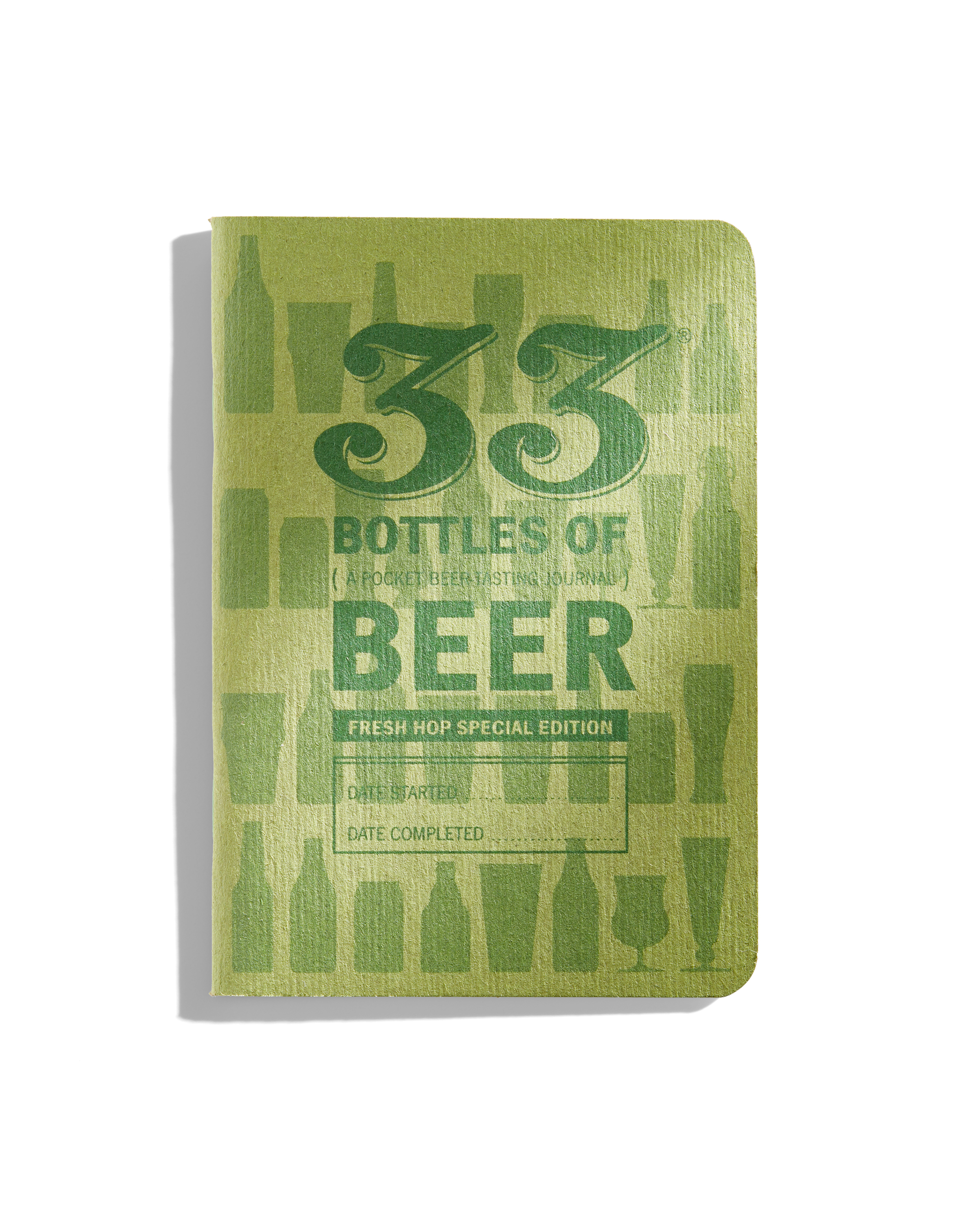 The distinctive cover of the hop-focused pocket beer journal is printed in green ink with green staples binding the pages together. (image courtesy of 33 Books)
