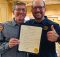 Dan Kent, Salmon-Safe co-founder and executive director, and Hopworks founder Christian Ettinger with the official proclamation naming Saturday August 25 as Salmon-Safe Day in Portland. (image courtesy of Hopworks Urban Brewery and Salmon-Safe)