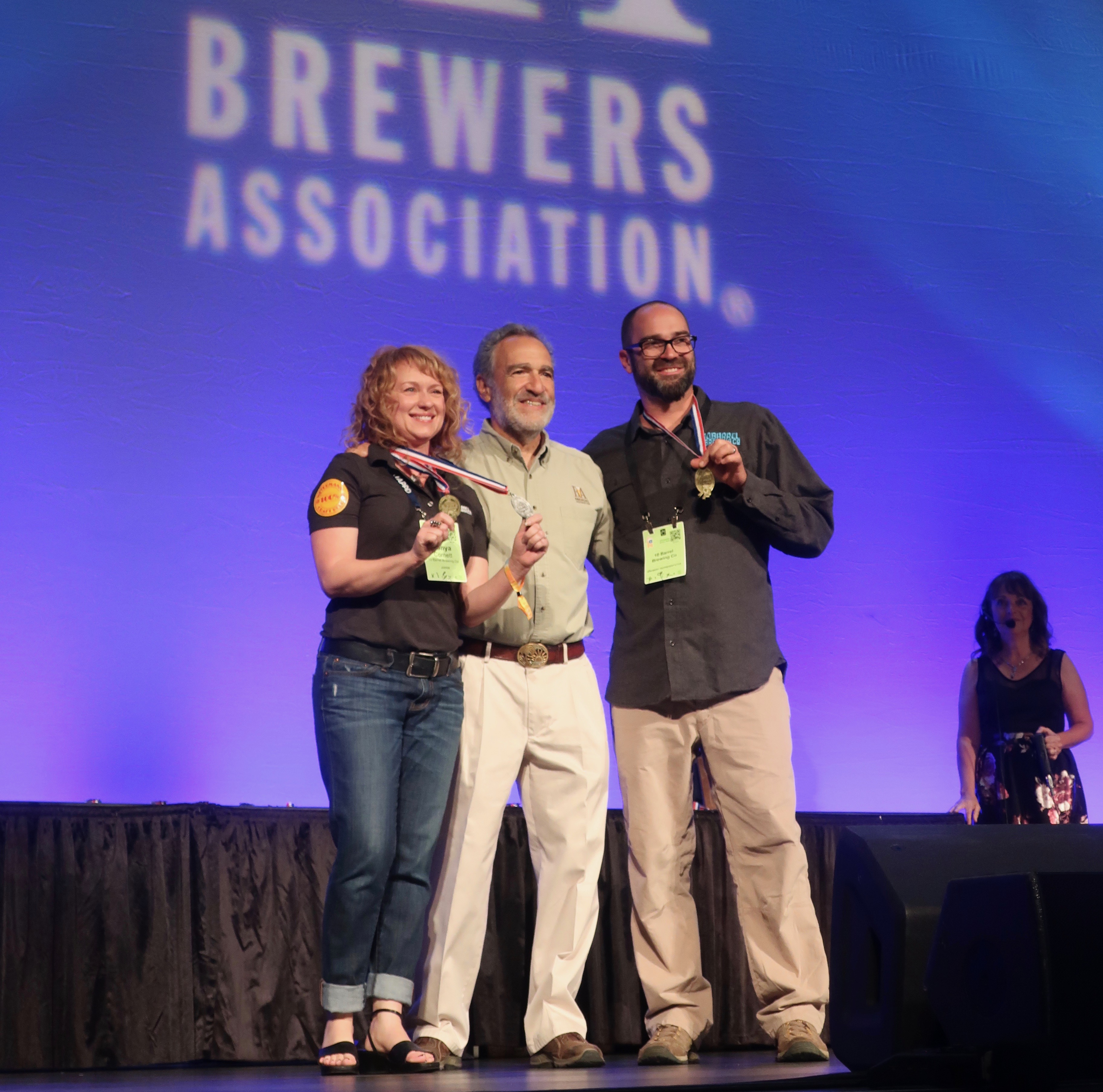Tonya Cornett and Ian Larkin of 10 Barrel Brewing on stage for their 3rd GABF Medal at the 2018 Great American Beer Festival.