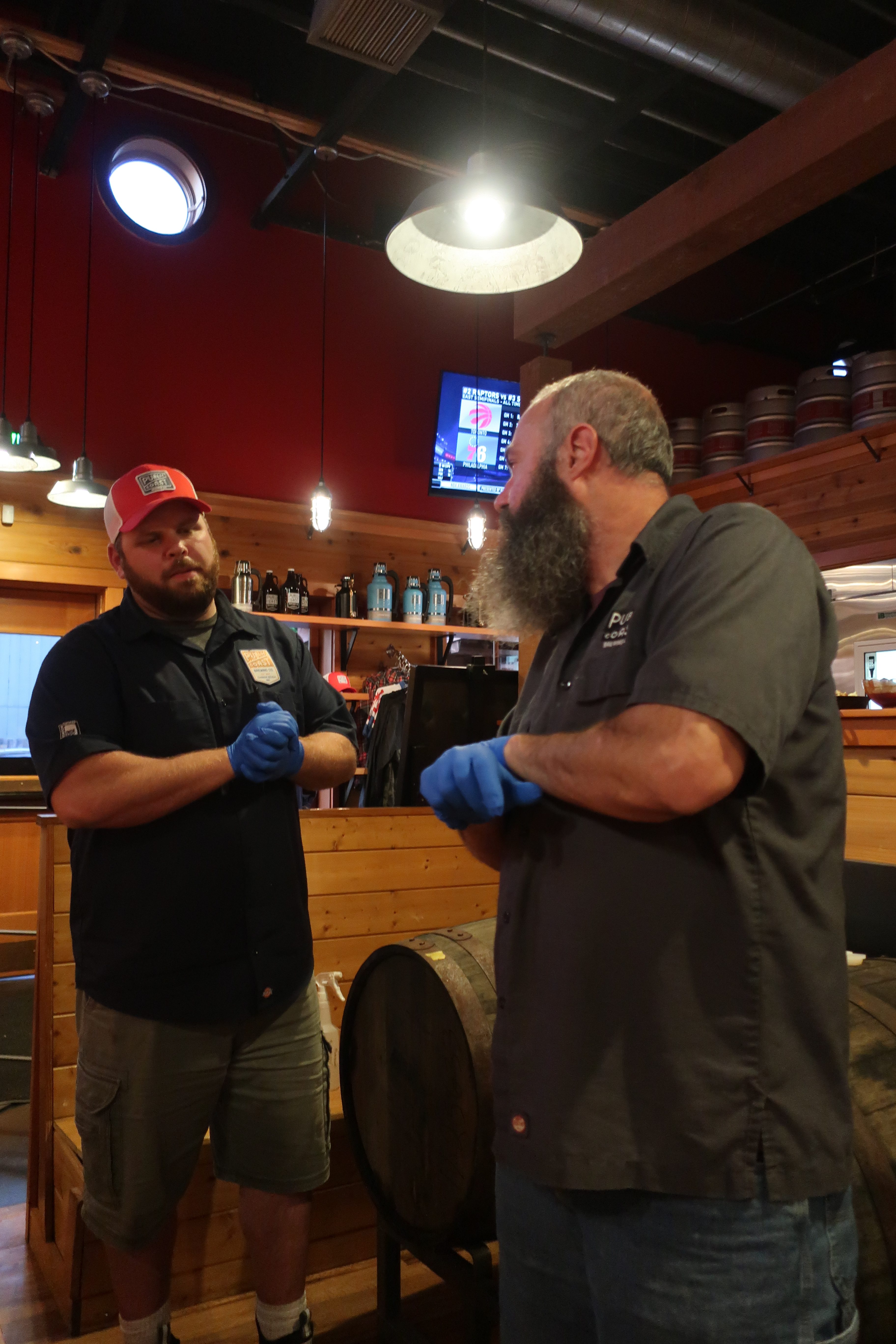 Will Leroux (right) and Ben Christianson about to serve a barrel-aged beer directly from the spirits barrel at Public Coast Brewing.