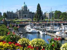 A view of the the harbor with the capitol building in the background in Victoria, BC