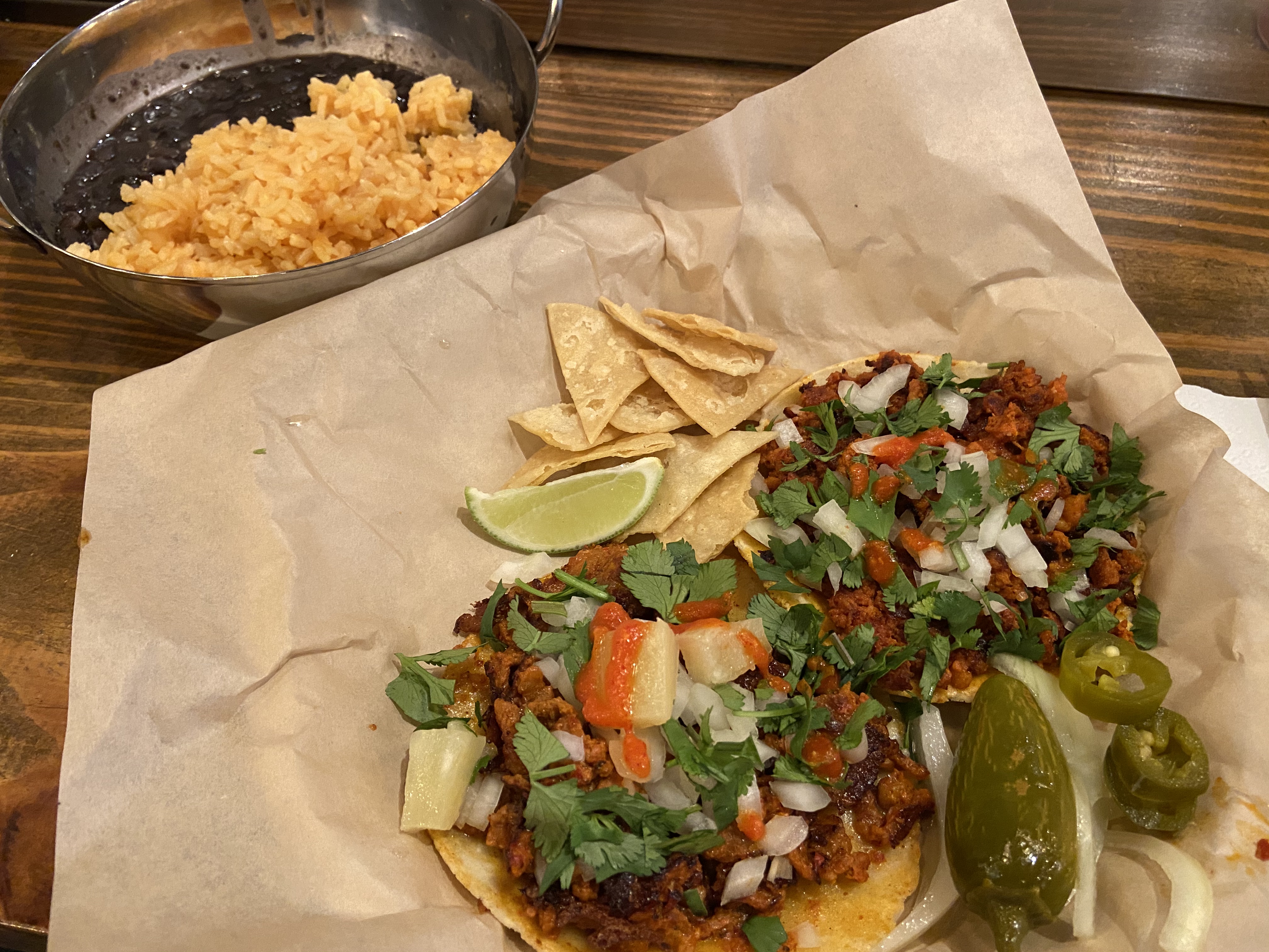 An order of two tacos and a side of beans and rice at Tight Tacos located inside Thirsty Monk.
