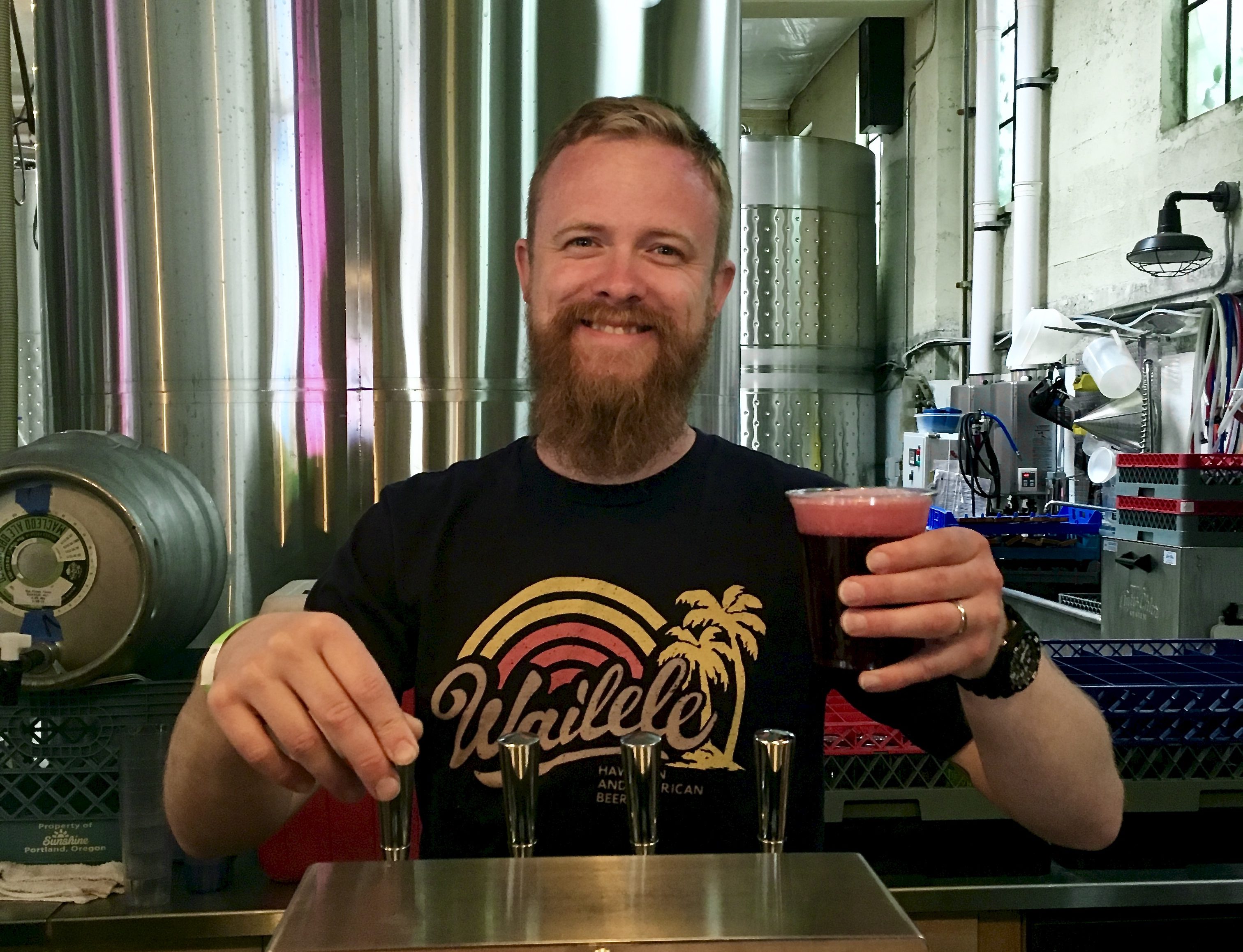 Reverend Nat West serving a cider at Reverend Nat's Hard Cider in NE Portalnd.