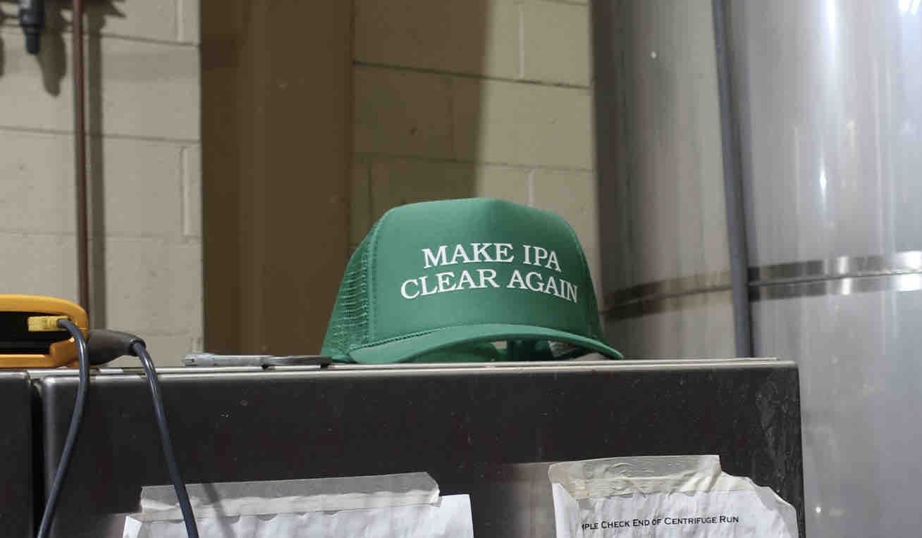 A Make IPA Clear Again hat that was gifted to Pelican Brewing from Comrade Brewing from Denver, Colorado