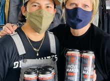 image of Dovetail Workwear's Sara DeLuca and Deschutes brewer Veronica Vega holding cans of Move Maker Cold IPA courtesy of Dovetail Workwear