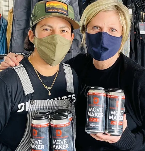 image of Dovetail Workwear's Sara DeLuca and Deschutes brewer Veronica Vega holding cans of Move Maker Cold IPA courtesy of Dovetail Workwear