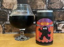 A snifter pour of Black Yeti Grisly's Cosmic Black Bourbon & Cola.