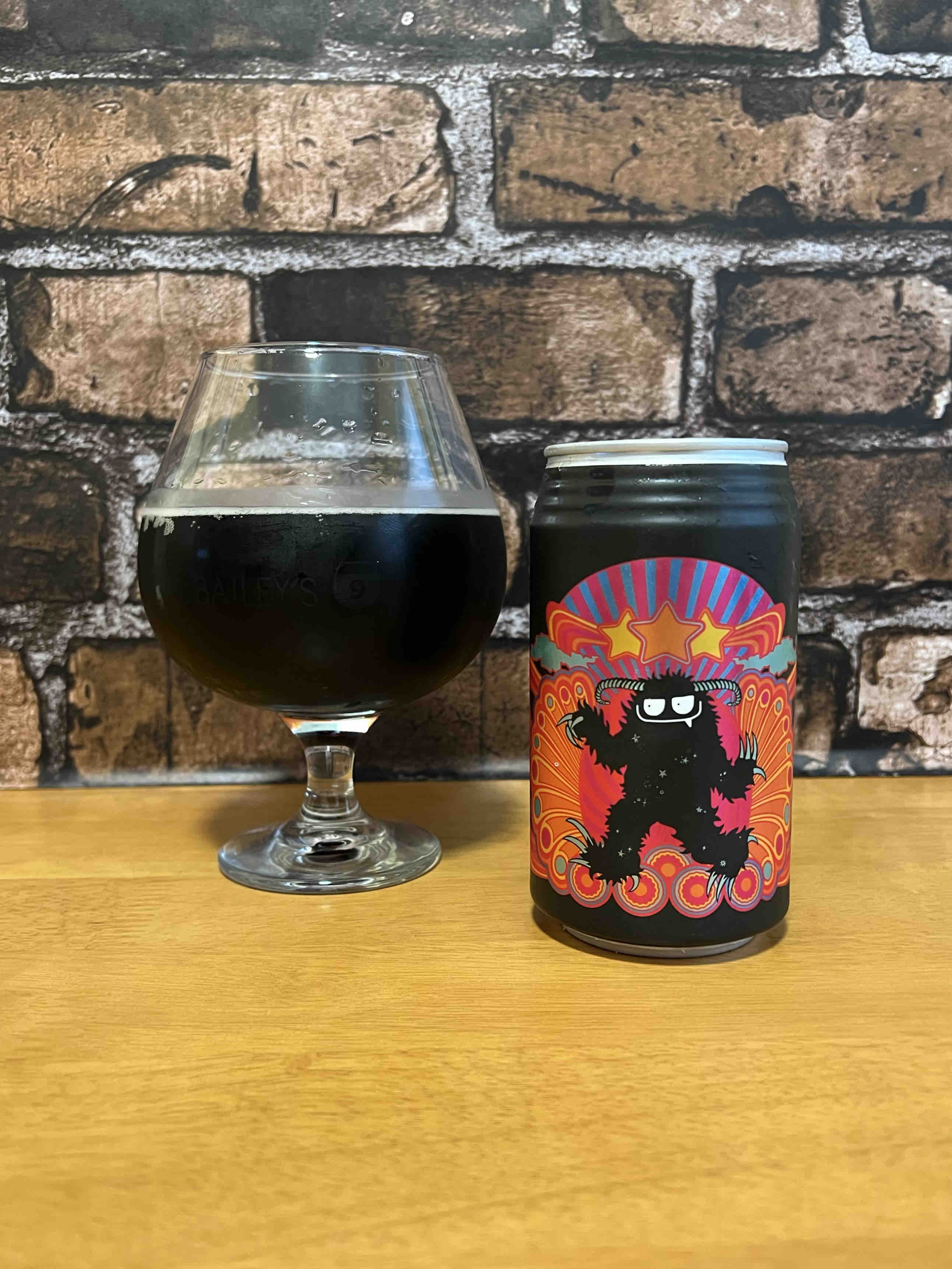 A snifter pour of Black Yeti Grisly's Cosmic Black Bourbon & Cola.