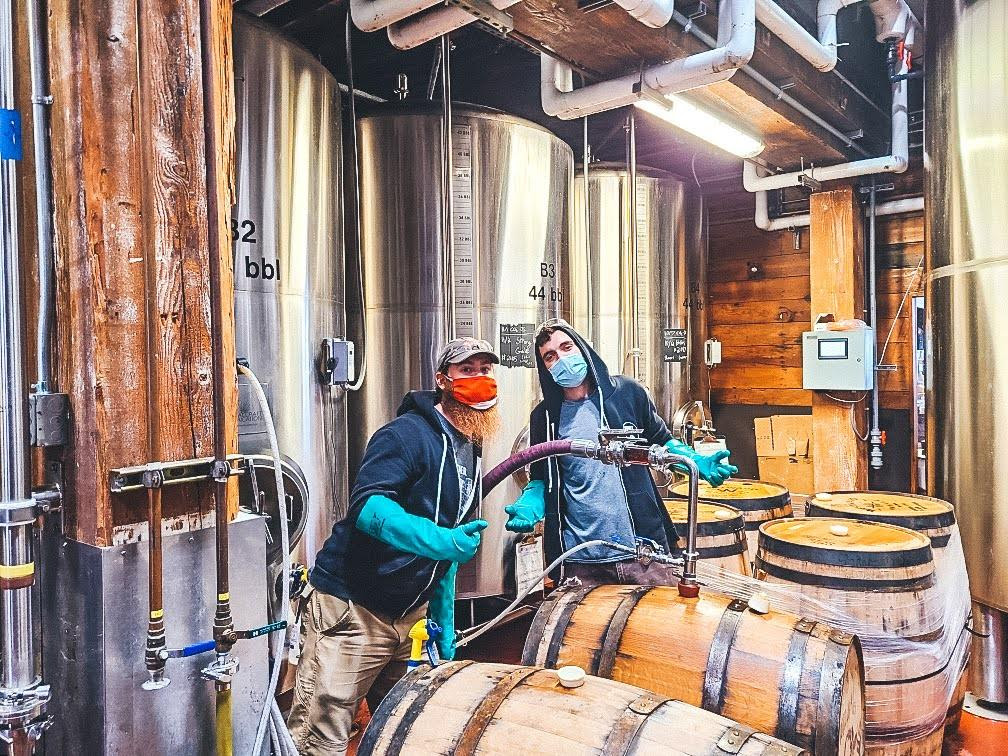 Alex Shores & Kyle Fosbinder transferring the Decapitator from barrels. (image courtesy of Buoy Beer)
