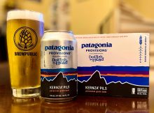 A can of Dogfish Head Craft Brewery and Patagonia Provisions Kernza Pils served in a BREWPUBLIC glass.