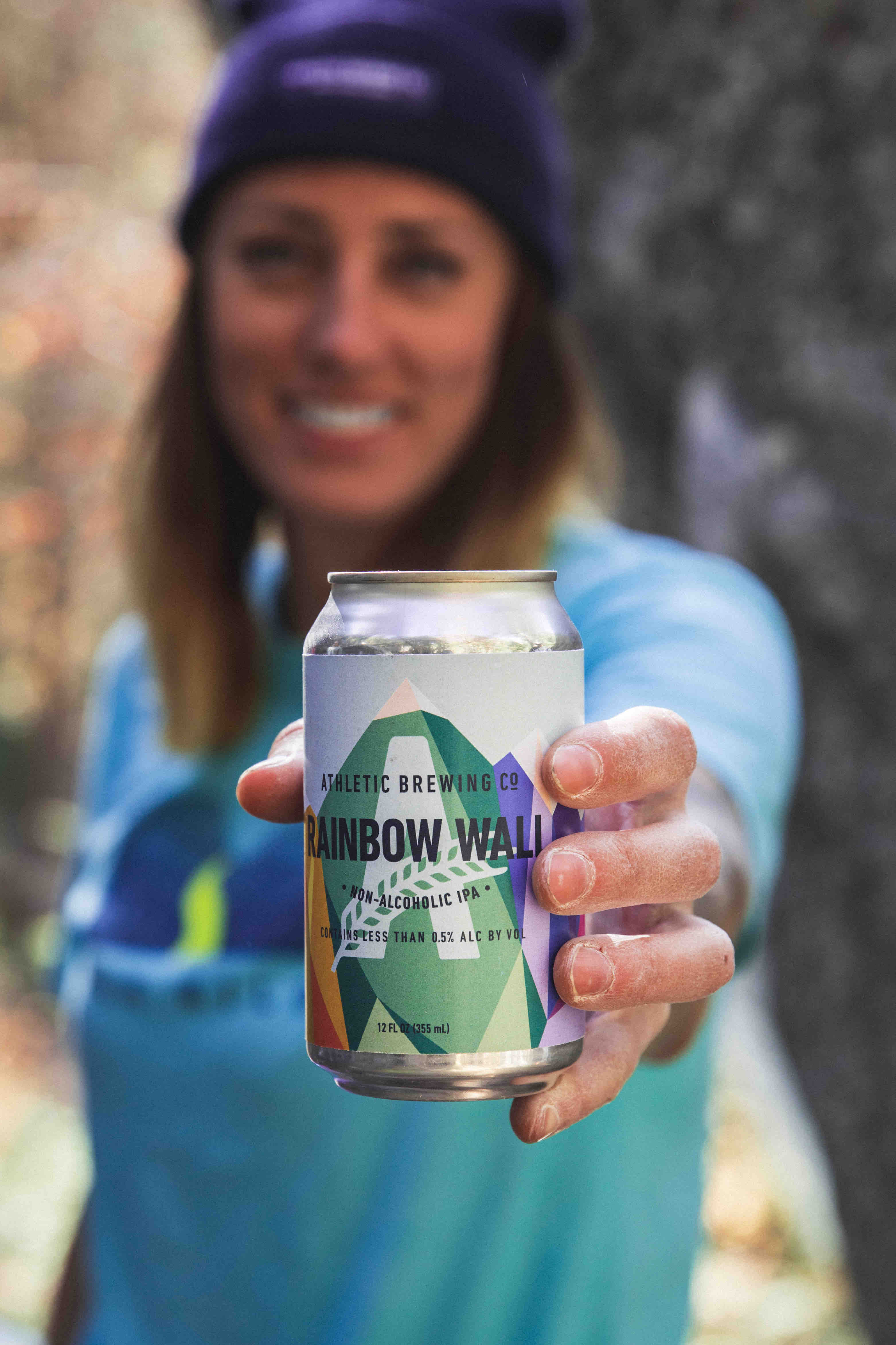 image of Alex Johnson holding a can of Rainbow Wall courtesy of Athletic Brewing Co.