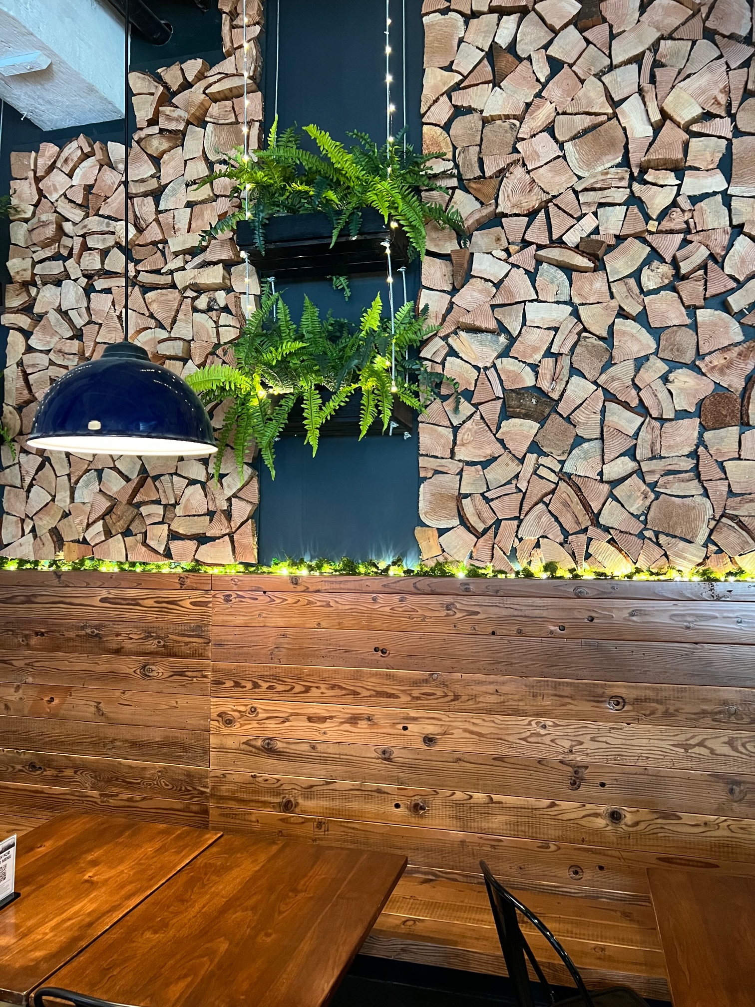 The lower wood panels are salvaged from Sunshine Dairy while the cut wood logs are from Whitney Burnside's father's property on Whidbey Island.
