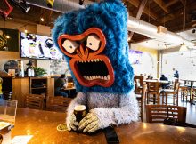 Mt. Abom at the bar looking with an Abominable Winter Ale in hand! (image courtesy of Hopworks Brewery)