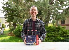 Oregon Artist Ben Woodcock with a 6-Pack of 2023 Jubelale. (image courtesy of Deschutes Brewery)