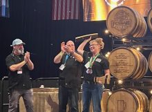 Tonya Cornett of 10 Barrel Brewing accepting her third medal at the 2023 Festival of Wood and Barrel Aged Beer.