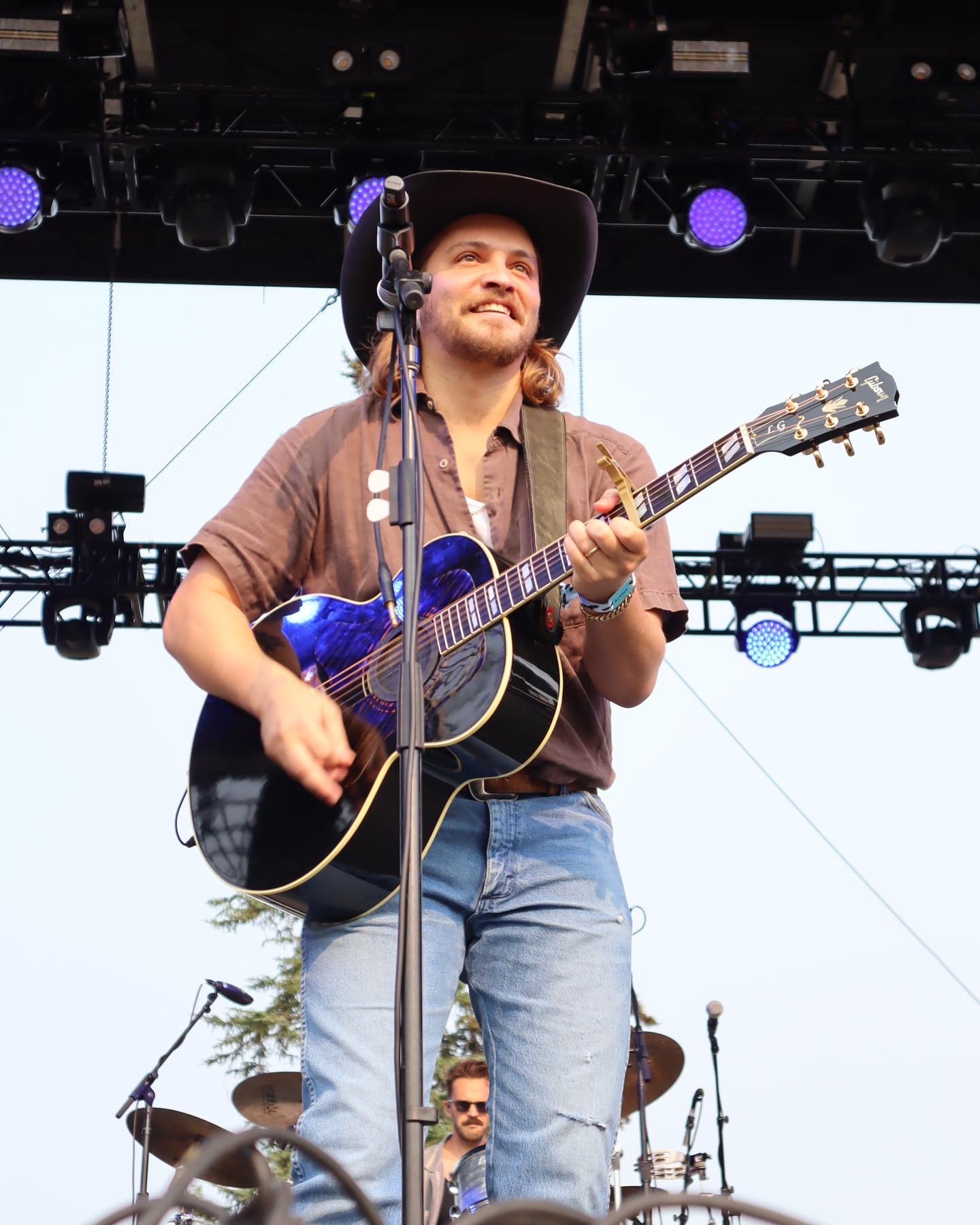 Luke Grimes of Yellowstone fame performing on stage at the 2023 Under the Big Sky Fest.