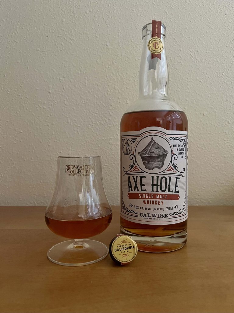 A neat pour of Axe Hole Single Malt Whiskey from Calwise Spirits and Firestone Walker Brewing